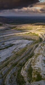 The Burren, in County Clare, is a remarkable limestone area that is unique in Europe. Its geology, flora, caves, archaeology, history and farming traditions set it apart as a place of great mystery and beauty. Arctic and Alpine flowers grow, surprisingly, alongside Mediterranean species and there are over 2,700 recorded monuments, some dating back over 6,000 years.